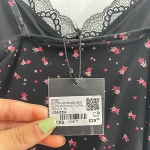 Selling a black bodycon lace trim mesh dress with pink ditsy floral on it.